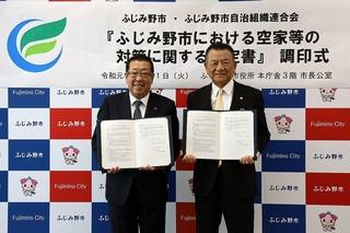 自治組織連合会の代表の方と空家等対策協定書を見せながら一緒に写した写真