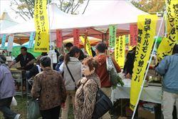 ふじみ野市産業まつりで、出店の前に並ぶ男女の写真