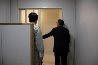 入口をあけ視察をしている市長の後ろ姿の写真
