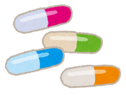 赤、青、緑、オレンジ色のカプセル型の薬のイラスト