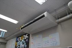 教室の天井近くに設置されたエアコンの写真