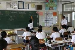 大井西中学校にて授業中に黒板で問題を解く生徒を見学する市長の写真