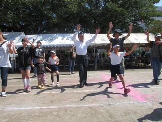 市長と保護者、児童が両手を上に挙げて、笑顔で写っている写真
